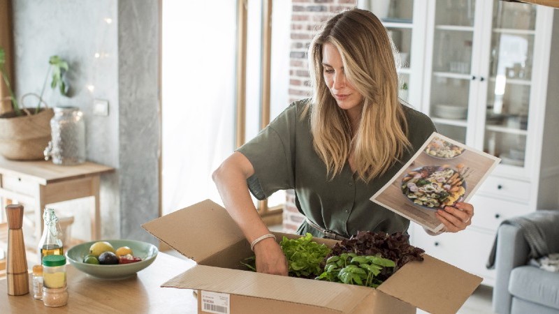image of a woman opening a box